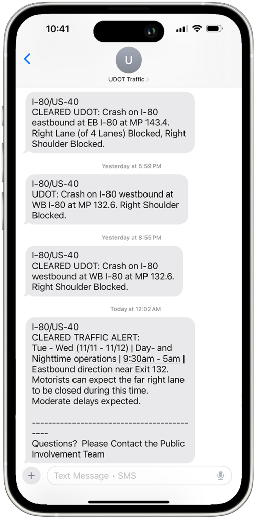 A phone with text alerts from UDOT Traffic.