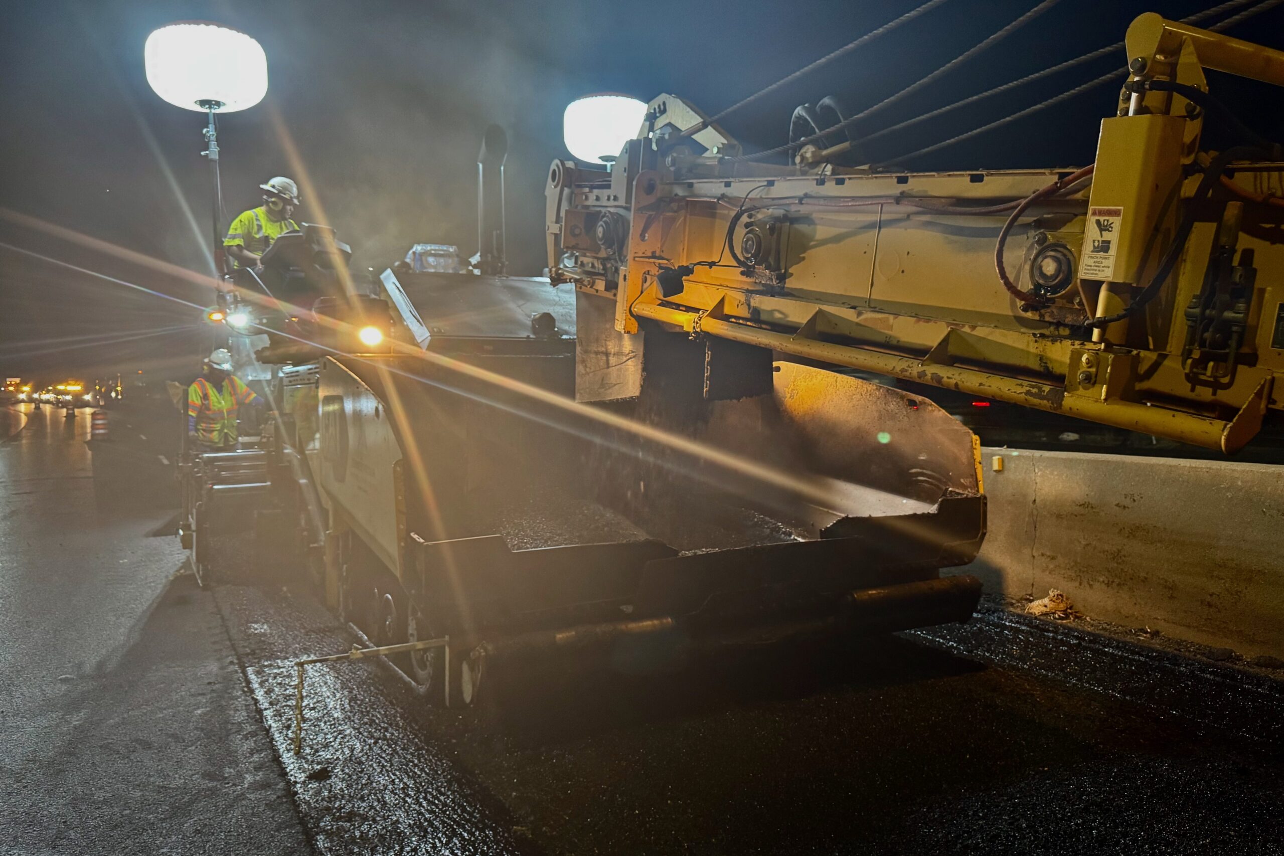 A construction crew works with a paver on I-80 Parleys Canyon.