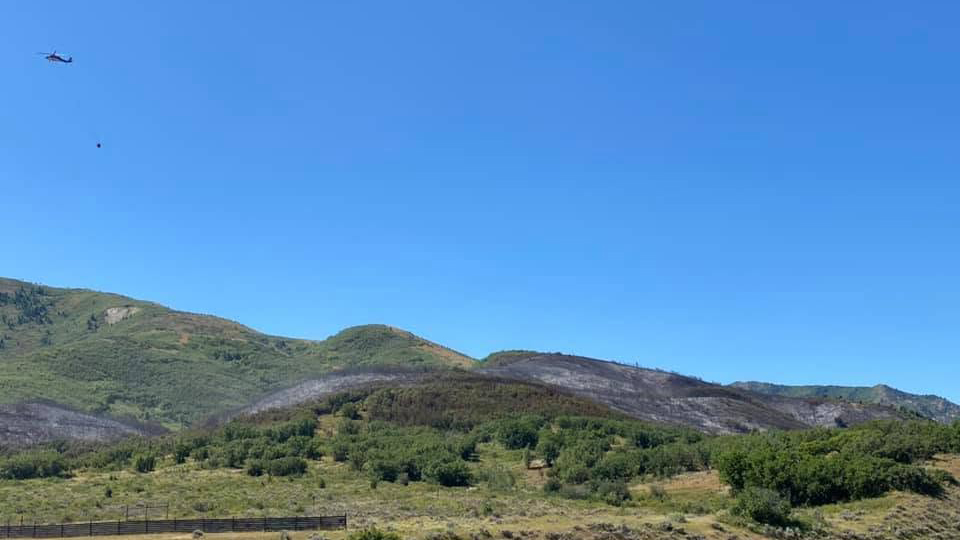 A helicopter drops water on the Parleys Fire in the mountains off I-80 near Mt. Aire.