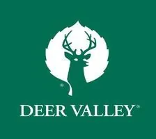 Deer Valley logo, with a deer silhouette on a leaf over a green background.
